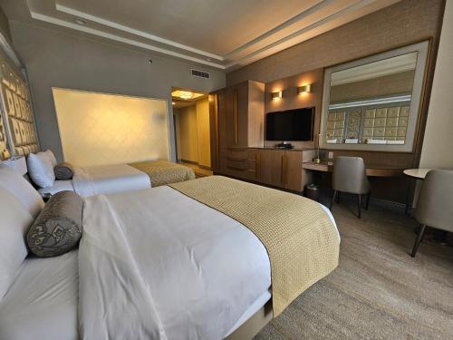 a hotel room with a large bed and a desk at LeoPalace Resort Guam in Yona