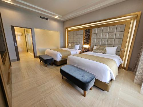 a hotel room with two beds and a chair at LeoPalace Resort Guam in Yona