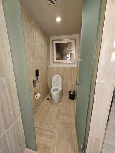 a bathroom with a toilet in a room at LeoPalace Resort Guam in Yona