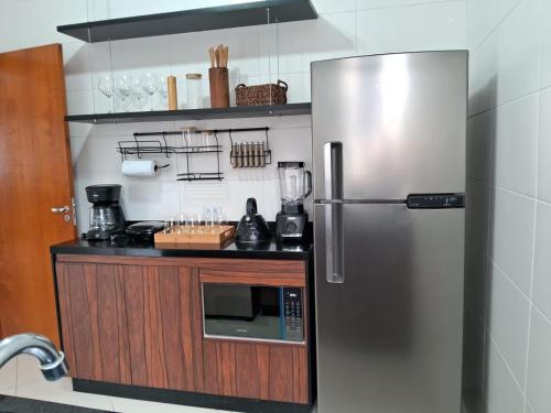 a kitchen with a stainless steel refrigerator at Apto Residencial Monte Carlo em São Roque 01 in São Roque