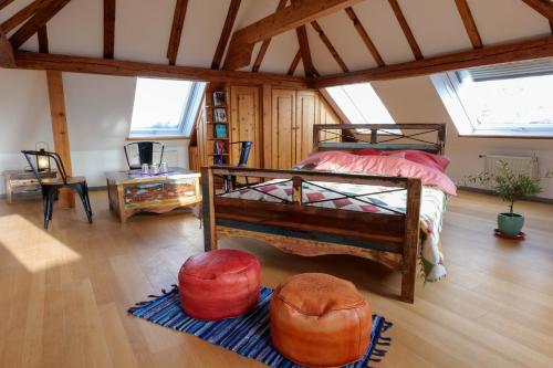 a bedroom with a bed and two ottomans at Goldener Löwe in Bodman-Ludwigshafen