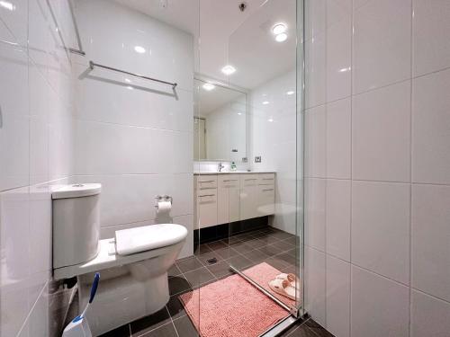 a bathroom with a toilet and a shower with a mirror at Share House Master Room Near Chatswood Station in Sydney