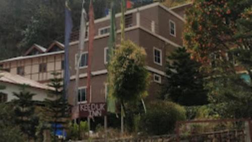 a large building with a sign in front of it at Hotel Keeduk Inn Dirang in Dirang Dzong