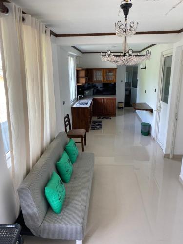 a living room with a couch and a chandelier at Lemazone Inn in Mirissa
