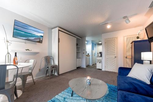 a living room with a blue couch and a table at The Shores in Williamsburg