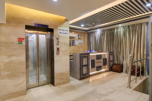 a lobby with an elevator and a door in a building at Hotel HSP Suites At Delhi Airport in New Delhi