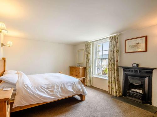 a bedroom with a bed and a fireplace at 1 bed in Eskdale SZ503 in Beckfoot