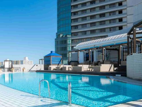 a large swimming pool on the roof of a building at Grand Prince Hotel Osaka Bay in Osaka