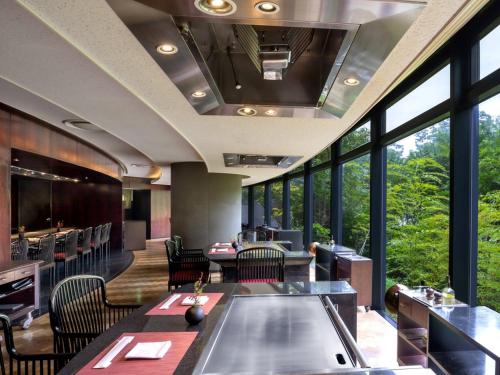 a restaurant with tables and chairs and large windows at Grand Prince Hotel Osaka Bay in Osaka