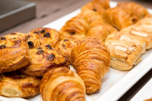 a tray of croissants and other pastries on display at Pace 1954 Hotel in Arco