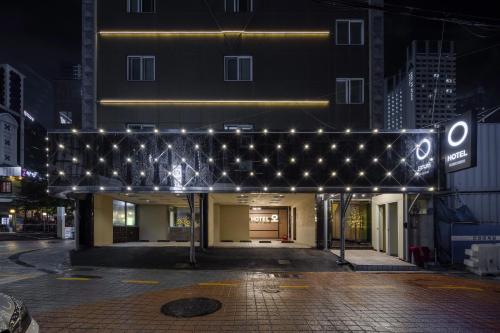 a building with a lit up facade at night at BELMORE Hotel in Busan