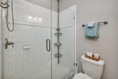 a bathroom with a toilet and a glass shower at Island Retreat in Glynn Haven in Saint Simons Island