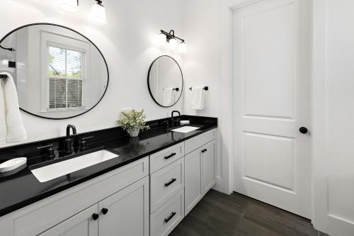 a bathroom with two sinks and a mirror at Ocean Pearl in Saint Simons Island