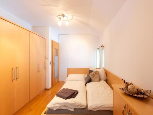 a small bedroom with a bed and a desk at Apartment in Niedernsill near Ski Slopes in Niedernsill
