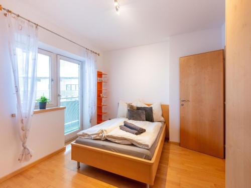 a bedroom with a bed and a window at Exclusive panoramic apartment in Niedernsill in Niedernsill