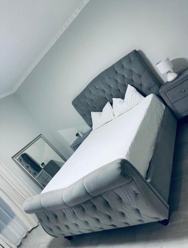 a bedroom with a large bed with a headboard at Luna Holiday Home in Maun