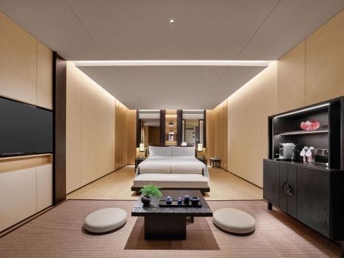 a hotel room with two beds and a television at Hilton Nanjing Niushoushan in Nanjing