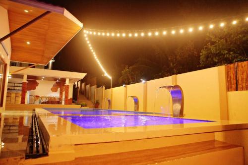 a swimming pool with blue lighting in a house at Terraza de Mari in Amadeo