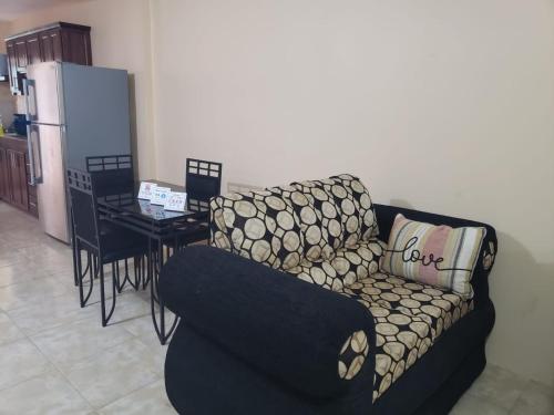 a living room with a couch and a table at 3bedrm, 2 bthrm. 7East Greater Portmore in Portmore