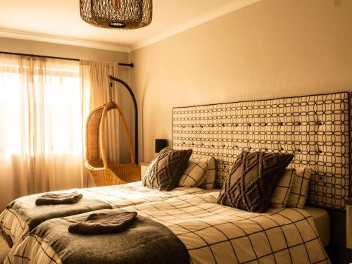 a bedroom with two beds and a large window at Witsand Whalecliff accommodation in Witsand