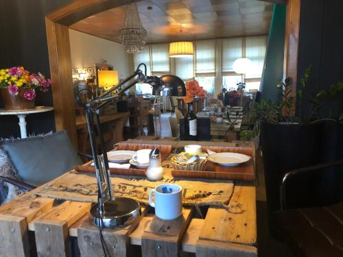 a wooden table with a lamp on top of it at beans parc hotel jade in Wilhelmshaven