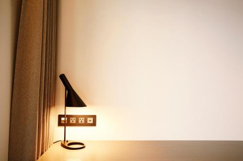 a lamp sitting on a bed in a room at MD HOTEL Dongtan in Hwaseong
