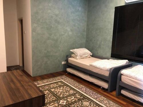 a room with a bed and a window and a rug at Orak Villa @ Kayangan Heights in Shah Alam