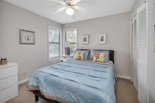 a bedroom with a bed and a ceiling fan at Harbour Oaks 606 in Saint Simons Island