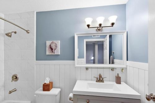a bathroom with a sink and a mirror at Turtle Cove in Saint Simons Island