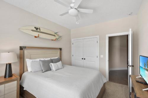 a bedroom with a bed with a surfboard on the wall at Kirkland Cottage in Saint Simons Island