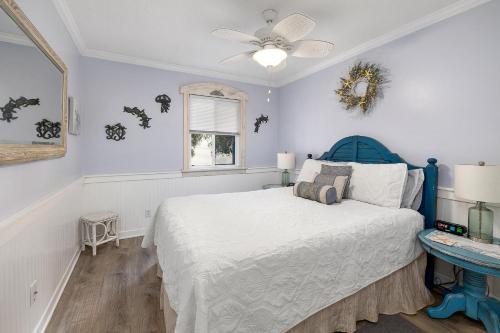 a bedroom with a blue bed and a window at Ocean Walk B-6 in Mallory Park