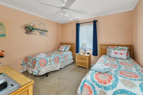 a bedroom with two beds and a sink at Ocean Walk H-14 in Saint Simons Island