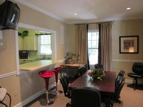 a living room with a table and a kitchen at Ocean Walk H-14 in Saint Simons Island