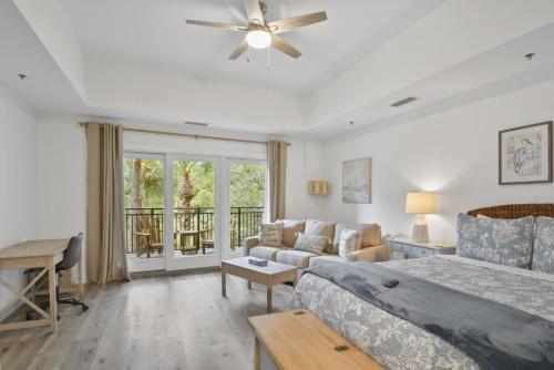 a bedroom with a bed and a living room at Salt Therapy in Saint Simons Island