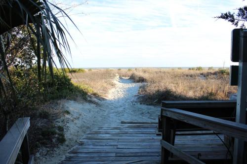 a dirt path through a field with the beach at Shipwatch 304 in East End