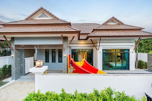 a house with a red and yellow object in front of it at Villa Me&you4 in Ban Bo Fai (1)