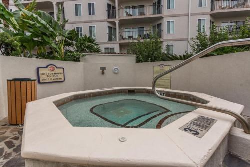 a jacuzzi tub in a patio next to a building at Beach Club 327 in East End