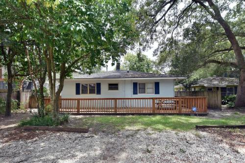 a small white house with a wooden fence at 1058 Sherman Avenue in Saint Simons Island