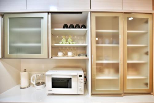 a kitchen with a white microwave and a counter at kameido k hotel in Tokyo