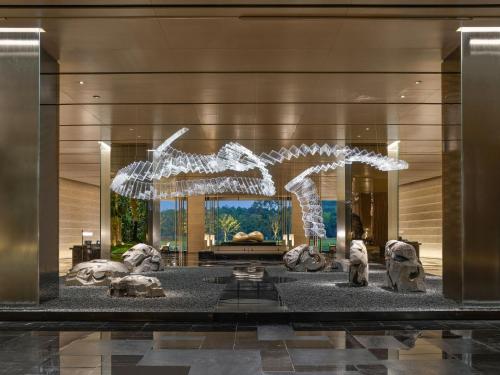 a lobby of a building with a sculpture of animals at Hilton Nanjing Niushoushan in Nanjing
