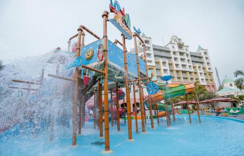 a water park with a water slide in front of a hotel at Wonderla Resort in Kumbalgod