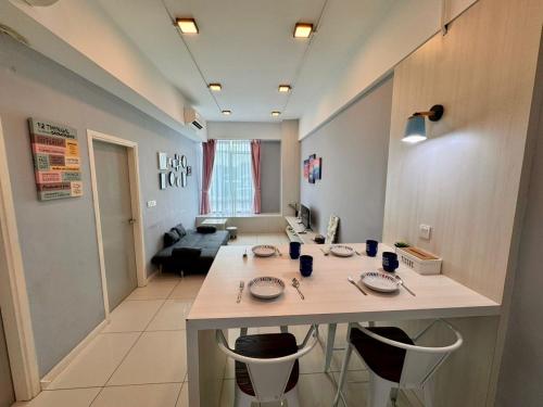 a kitchen and living room with a table and chairs at SA Sutera Avenue Homestay Opposite Imago KK in Kota Kinabalu