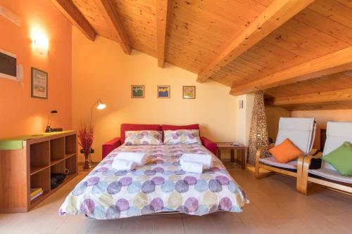 a bedroom with a large bed and two chairs at hiresicily - Appartamento Eucaliptus in Avola
