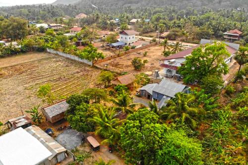 an aerial view of a village with houses and trees at Family Batcave Homestay in Battambang