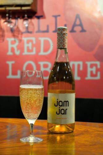 a bottle of beer sitting next to a glass at Villa Red Lobster in Hikkaduwa