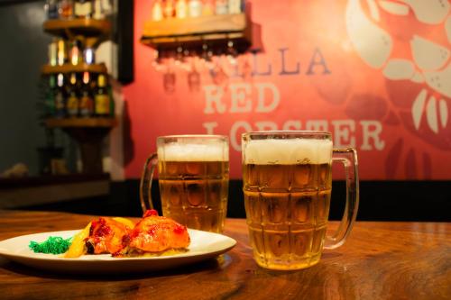 a plate of food and two glasses of beer at Villa Red Lobster in Hikkaduwa