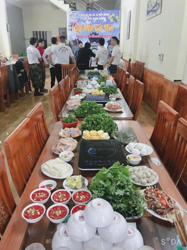 een lange tafel met veel borden eten erop bij Hotel Thi Hoa Bái Đính in Tiên Tân