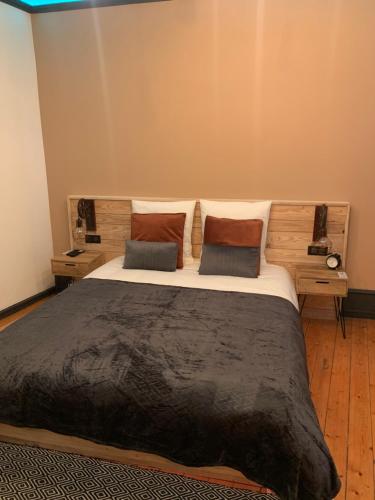 a bedroom with a large bed with two pillows at Édouard & Richard in Colmar