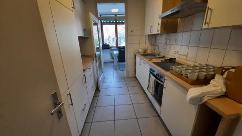 a kitchen with white cabinets and a stove top oven at Black Stone Apartments - Lörrach in Lörrach