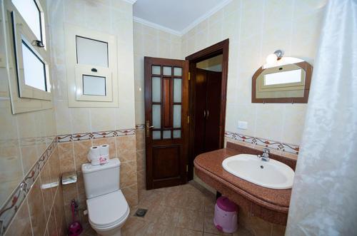 a bathroom with a toilet and a sink at Sharks Bay Oasis Hotel in Sharm El Sheikh